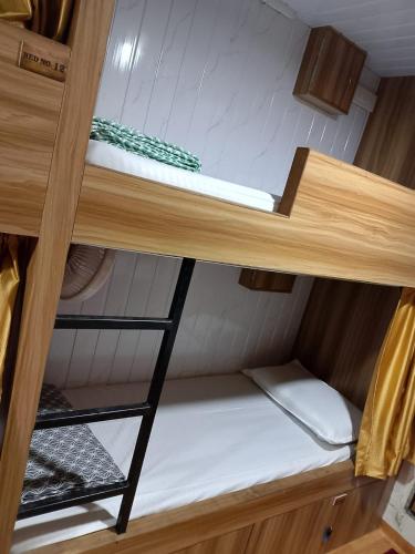 a bunk bed in a small room on a boat at Sun Shine AC Dormitory in Mumbai