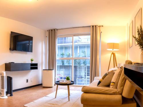a living room with a couch and a large window at Best location in Mexico City Cozy Master Suite in Mexico City