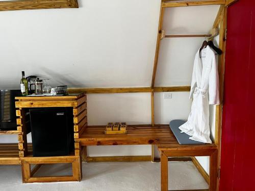 a room with a wooden table and a wooden bench at The Sea Cliff Hotel Resort & Spa in Port Antonio