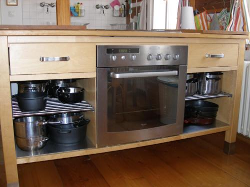 a kitchen with an oven with pots and pans at Pecka Penzion in Pec pod Sněžkou