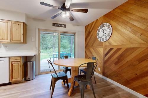 a kitchen with a table and chairs and a clock on the wall at Gold Rush Deck in Coeur d'Alene
