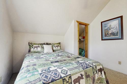 a bedroom with a bed with a horse blanket at Hunter's Paradise in New Meadows