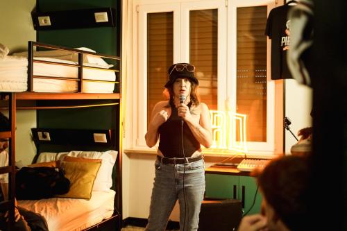a woman standing in a room holding a microphone at YellowSquare Milan in Milan
