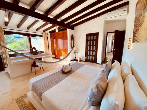 a bedroom with a large bed and a large window at Hotel Para Ti - Adults Only in Holbox Island