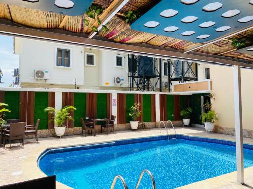 a swimming pool on a building with a hotel at Presken Hotel @Oniru in Lagos