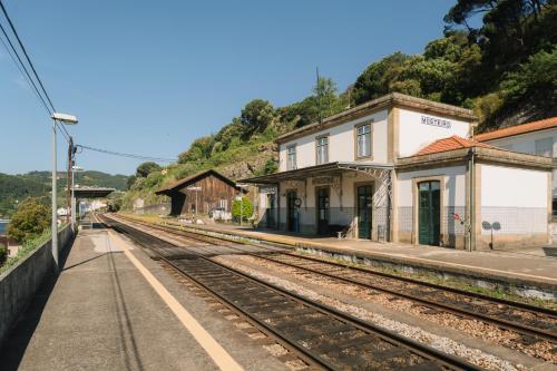 an old train station next to a train track at Estação de Mosteirô, Next Stop - by RowdHouses in Riba Douro