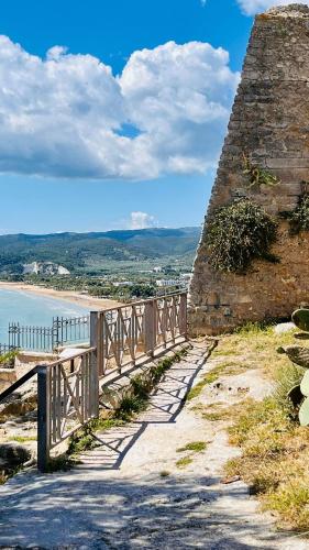 a stone wall with a bench next to the beach at Vieste Rooftop - Sea view near Pizzomunno - Free private Parking in Vieste