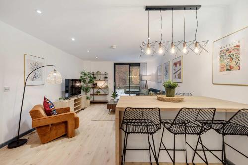 a kitchen and living room with a table and chairs at Baltic Apt II - City Centre with Parking, Sleeps 6 in Liverpool