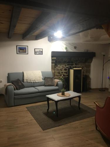 a living room with a couch and a coffee table at Gîte Therence chez Bruno in Sainte-Thérence