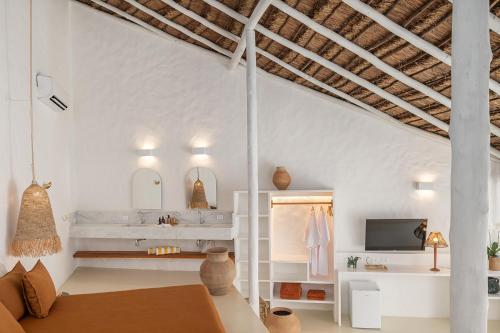 a white bathroom with a sink and a tv at Miradouro de São Sebastião in São Sebastião