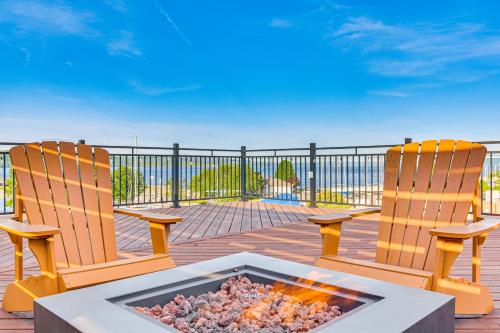 two chairs and a fire pit on a deck at 1 Block to Lake City Marina Condo with Rooftop Deck in Lake City