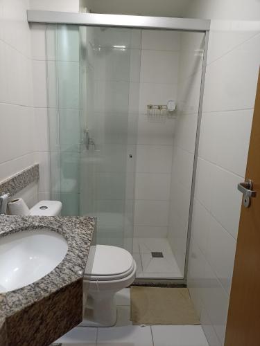 a bathroom with a shower with a toilet and a sink at S4 Hotel SUÍTE 1120 in Brasília