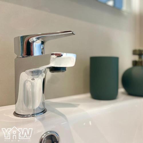 a bathroom sink with a faucet on a counter at Lucia's House in San Giovanni Rotondo
