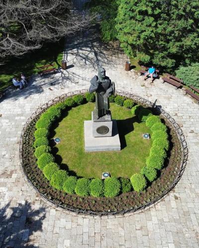a statue in the middle of a circle of grass at Apartments Mirković in Cetinje