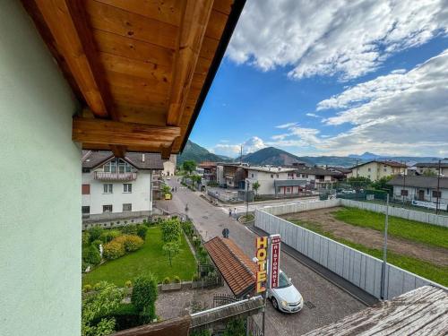 a view of a city from a balcony of a building at Hotel Caminetto - Rooms and Apartments in Cembra