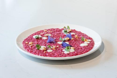 a bowl of red rice with blue flowers on it at Hotel Italia in Garda