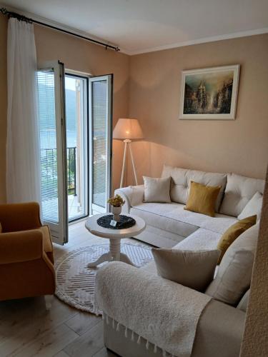 a living room with a couch and a table at House Hill Star Kumbor in Kumbor