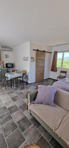 a living room with a couch and a table at Le petit Marius in Fayence