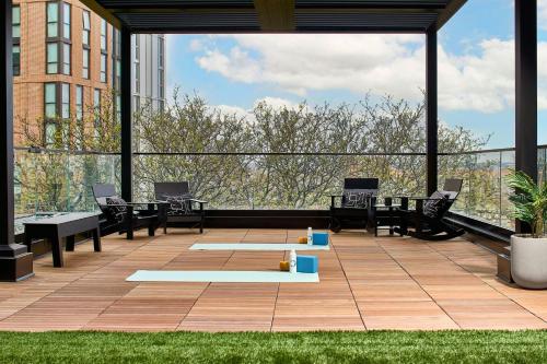 a large patio with chairs and tables on a building at Hotel Celare, Cincinnati Midtown, a Tribute Portfolio Hotel in Cincinnati