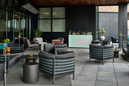 a restaurant with chairs and tables in a building at Hotel Celare, Cincinnati Midtown, a Tribute Portfolio Hotel in Cincinnati