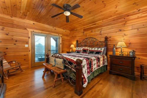 a bedroom with a bed and a ceiling fan at About the View in Black Mountain
