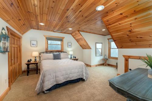 a bedroom with a bed and a wooden ceiling at About the View in Black Mountain