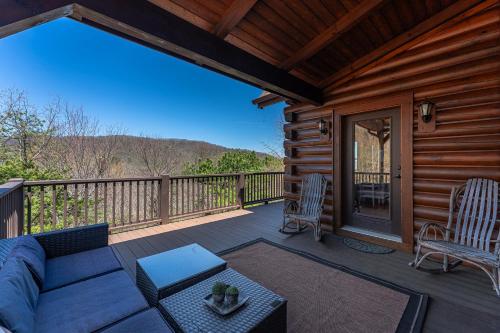 a patio with a couch and chairs on a deck at About the View in Black Mountain