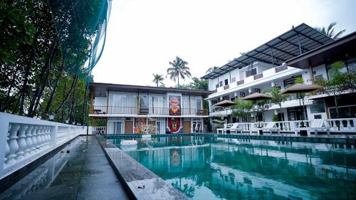 a large swimming pool in front of a building at Lake view Resort cherai in Cherai Beach