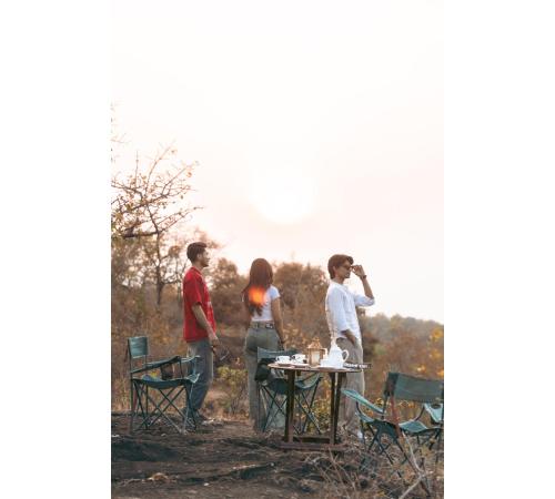 a group of people standing around a picnic table at Jungle Ghar in Pachmarhī