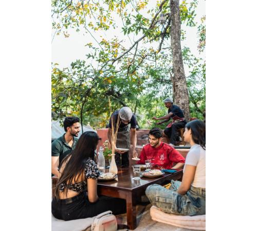 a group of people sitting around a table at Jungle Ghar in Pachmarhī