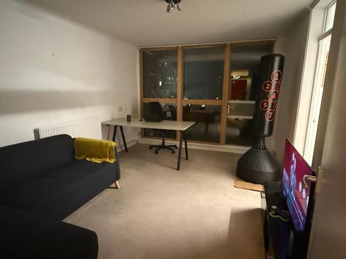 a living room with a couch and a table and a window at Homely 1BD Flat Central LDN Angel Kings Cross in London