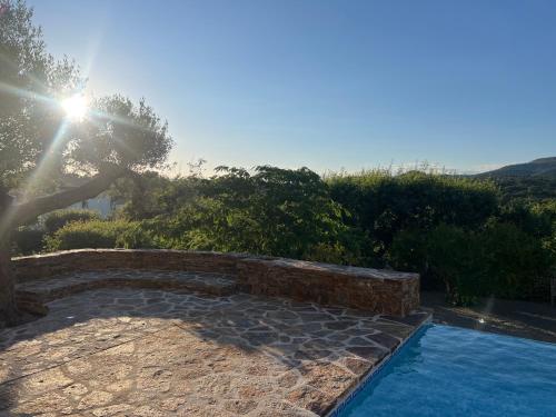 a swimming pool in a yard with the sun shining at Villa familiale avec vue imprenable in Saint-Raphaël