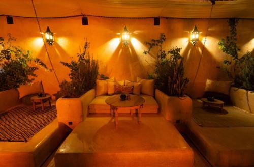 a living room with a couch and a table at Riad Nouceiba Marrakech in Marrakech