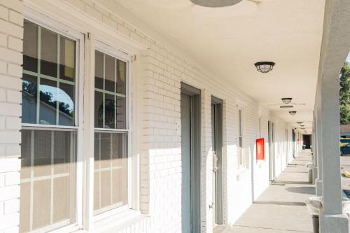 a row of windows on a white building at Thunderbird Motel in Savannah