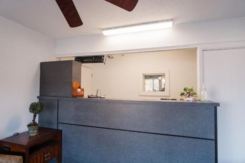 a kitchen with a counter and a refrigerator at Thunderbird Motel in Savannah