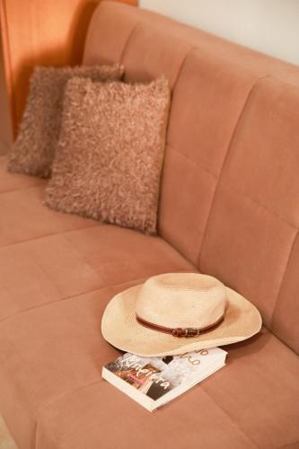 a straw hat sitting on top of a couch at Ioli Luxury Apartment in Gourna