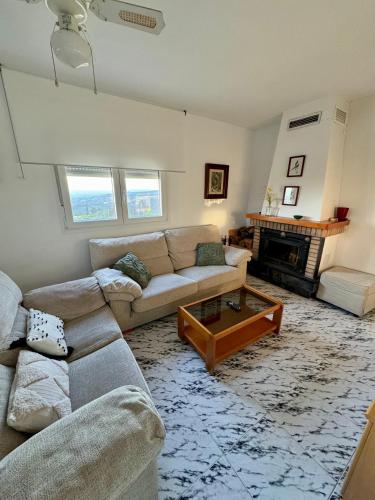a living room with a couch and a coffee table at Casa rural Balcón de Monachil in Monachil