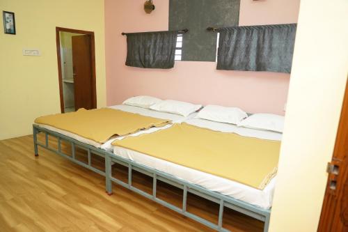 a couple of beds in a room at AJ GrandInn in Podanūr
