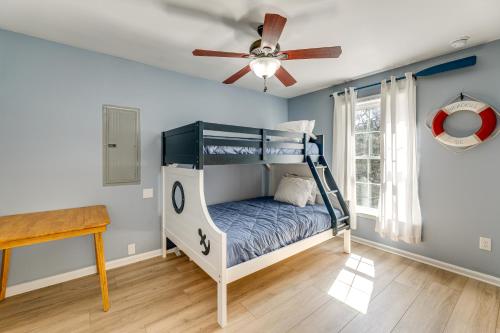 a bedroom with a bunk bed and a ceiling fan at Broadkill Beach Gem with Beach Access, Dogs Welcome in Milton