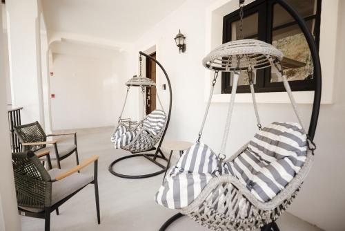 a room with two hanging chairs and a mirror at El Prado: New 2br Condo in Las Catalinas in Playa Danta