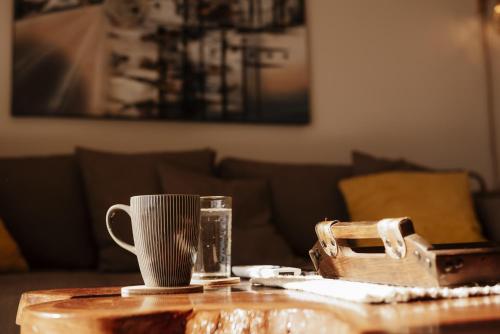 a coffee table with a cup and a mug at El Prado: New 2br Condo in Las Catalinas in Playa Danta