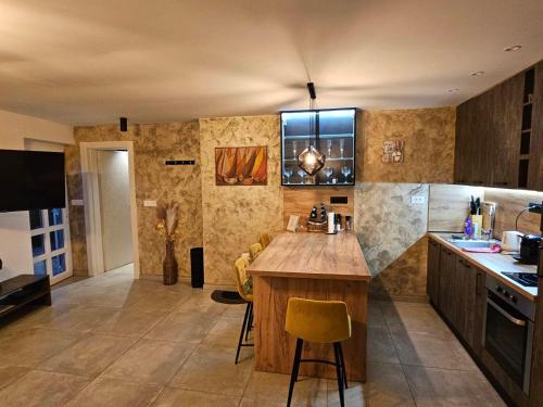 a kitchen with a island in the middle of a room at Apartman Noa in Kastav