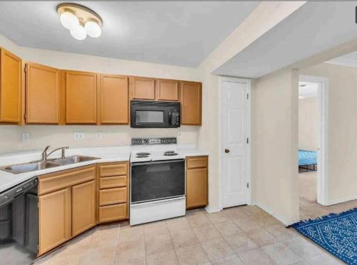 a kitchen with a sink and a microwave at Property near to Airport and Free Parking in Ascalon