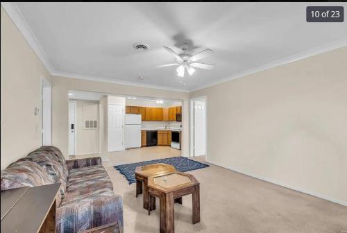 a living room with a couch and a ceiling fan at Property near to Airport and Free Parking in Ascalon