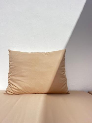 a pillow sitting on top of a bed at Casa Z Morocco in Tamraght Ouzdar