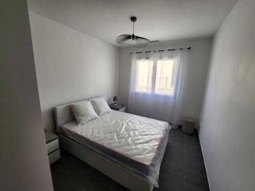 une petite chambre avec un lit et une fenêtre dans l'établissement La Villa les Terrasses du Canal, à Capestang