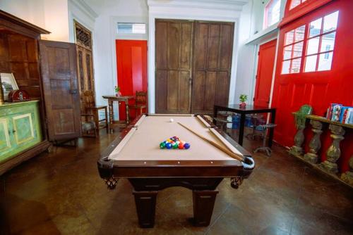 a pool table in a room with red walls at Engine 24 Firehouse Bed & Breakfast in New Orleans