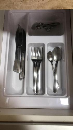 a white tray with utensils sitting on a counter at PARK VEREDAS - Apto 415 - Vista para Piscina in Rio Quente