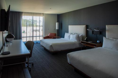 a hotel room with two beds and a desk at Courtyard by Marriott Lake City in Lake City