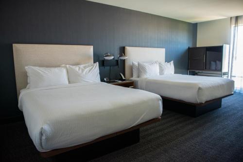 a hotel room with two beds and a tv at Courtyard by Marriott Lake City in Lake City